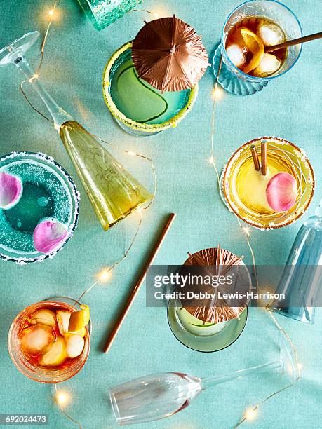 decorative lights and party cocktails - paper umbrella stock pictures, royalty-free photos & images