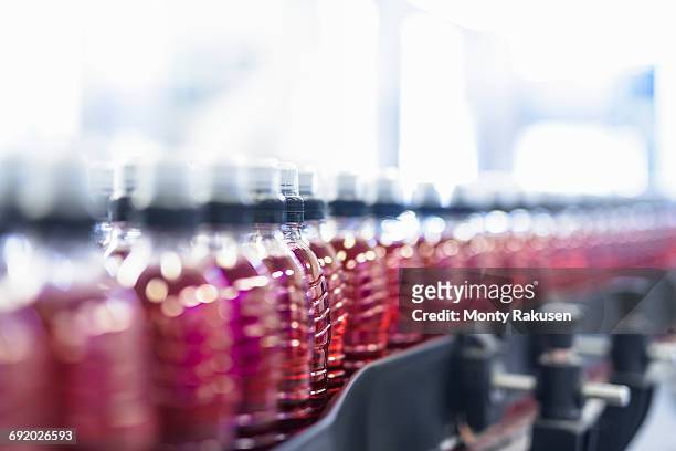 bottles filled with flavoured water on production line in spring water factory - food and drink industry ストックフォトと画像