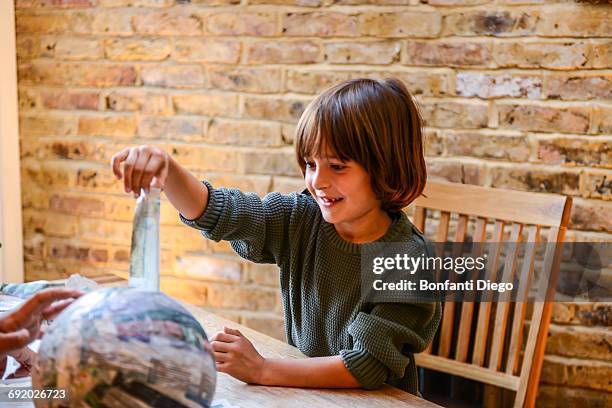 child playing with papier mache - papier stock pictures, royalty-free photos & images