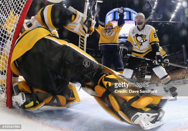 Mike Fisher of the Nashville Predators celebrates a goal by teammate James Neal as Ron Hainsey of the Pittsburgh Penguins reacts during the second...