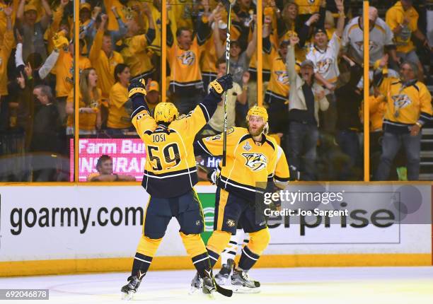 Mattias Ekholm of the Nashville Predators celebrates his third period goal with teammate Roman Josi during Game Three of the 2017 NHL Stanley Cup...