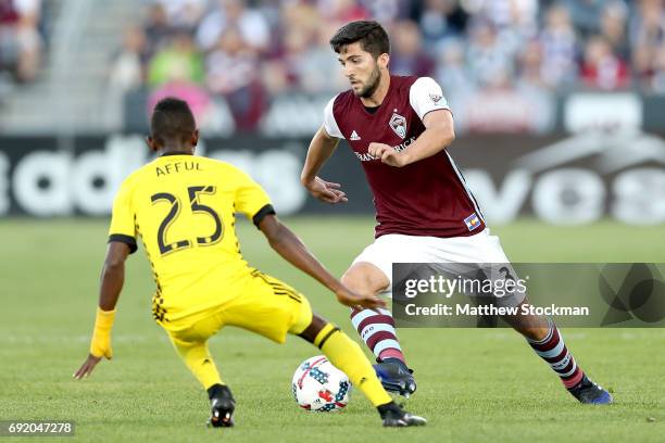 Eric Miller of the Colorado Rapids attempts to elude Harrison Afful of Columbus Crew SC at Dick's Sporting Goods Park on June 3, 2017 in Commerce...