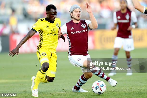 Mohammed Abu of the Columbus Crew SC fights for the ball with Dillon Powers of the Colorado Rapids at Dick's Sporting Goods Park on June 3, 2017 in...