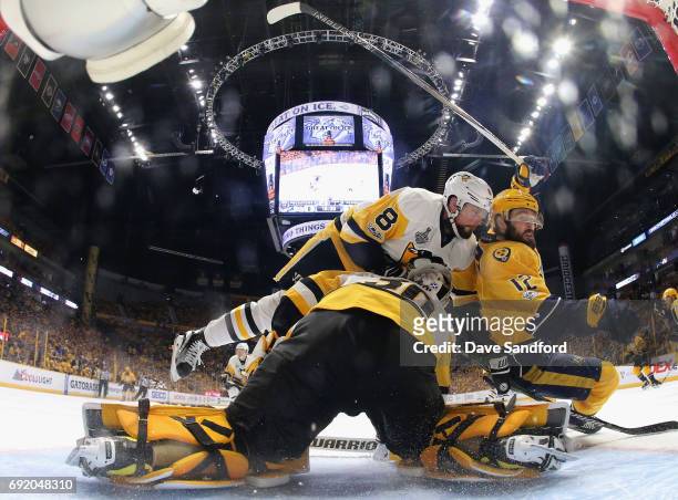 Brian Dumoulin of the Pittsburgh Penguins and Mike Fisher of the Nashville Predators collide and fall over goaltender Matt Murray during the second...