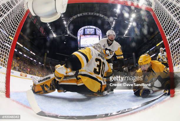 Mike Fisher of the Nashville Predators falls to the ice behind goaltender Matt Murray and Brian Dumoulin of the Pittsburgh Penguins during the second...