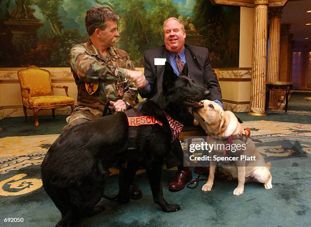 Michael Hingson shakes hands with Hal Wilson at the North Shore Animal League Americas Lewyt Humane Awards Luncheon January 9, 2002 in Garden City,...