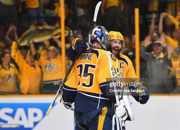 Mike Fisher of the Nashville Predators celebrates with goaltender Pekka Rinne after their team defeated the Pittsburgh Penguins 5-1 in Game Three of...