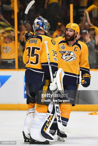 Mike Fisher of the Nashville Predators celebrates with goaltender Pekka Rinne after their team defeated the Pittsburgh Penguins 5-1 in Game Three of...