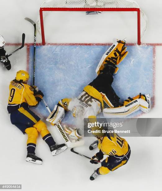 Filip Forsberg of the Nashville Predators and Pontus Aberg of the Nashville Predators converge on Matt Murray of the Pittsburgh Penguins at the...