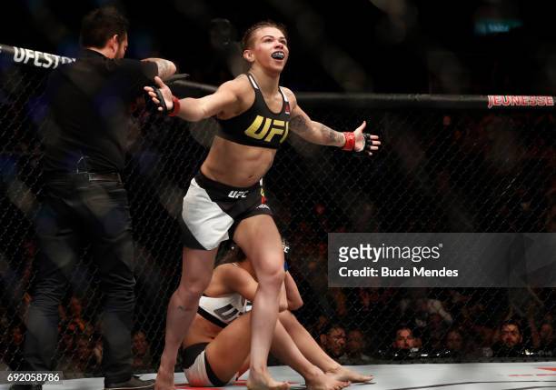 Claudia Gadelha of Brazil celebrates after her submission victory over Karolina Kowalkiewicz of Poland in their womens strawweight bout during the...