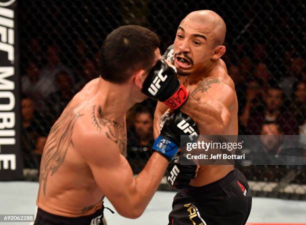 Jose Aldo of Brazil punches Max Holloway in their UFC featherweight championship bout during the UFC 212 event at Jeunesse Arena on June 3, 2017 in...