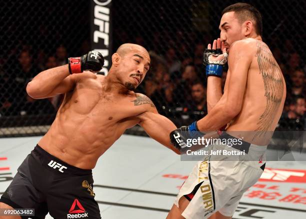 Jose Aldo of Brazil punches Max Holloway in their UFC featherweight championship bout during the UFC 212 event at Jeunesse Arena on June 3, 2017 in...