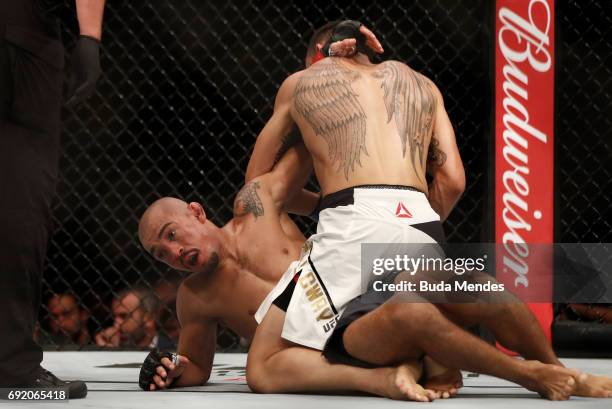 Max Holloway punches Jose Aldo of Brazil in their UFC featherweight championship bout during the UFC 212 event at Jeunesse Arena on June 3, 2017 in...