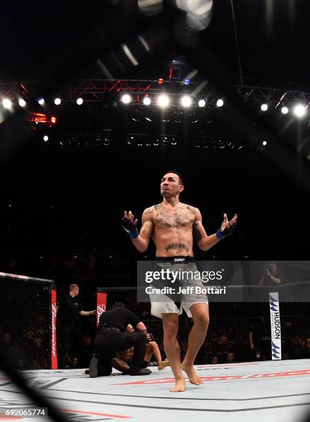 Max Holloway celebrates after his TKO victory over Jose Aldo of Brazil in their UFC featherweight championship bout during the UFC 212 event at...