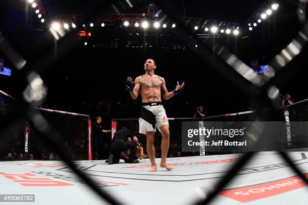 Max Holloway celebrates after his TKO victory over Jose Aldo of Brazil in their UFC featherweight championship bout during the UFC 212 event at...