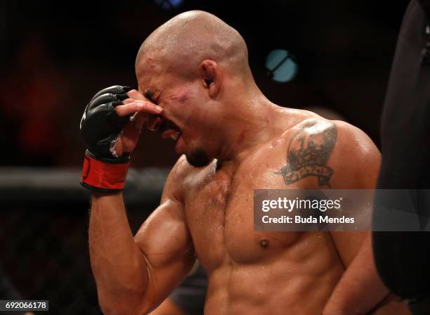 Jose Aldo of Brazil reacts after his TKO loss to Max Holloway in their UFC featherweight championship bout during the UFC 212 event at Jeunesse Arena...