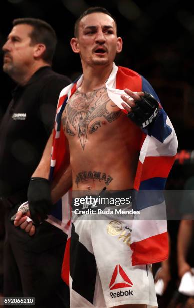 Max Holloway celebrates after his TKO victory over Jose Aldo of Brazil in their UFC featherweight championship bout during the UFC 212 event at...