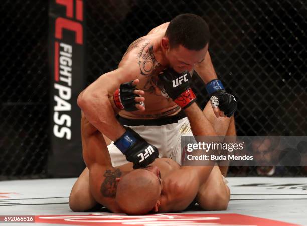 Max Holloway punches Jose Aldo of Brazil in their UFC featherweight championship bout during the UFC 212 event at Jeunesse Arena on June 3, 2017 in...