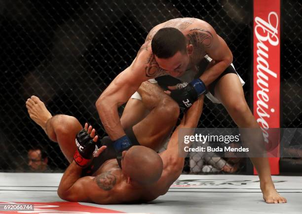 Max Holloway punches Jose Aldo of Brazil in their UFC featherweight championship bout during the UFC 212 event at Jeunesse Arena on June 3, 2017 in...