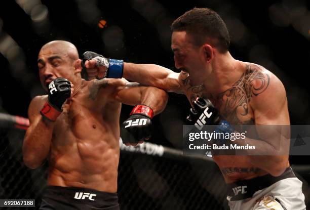 Max Holloway punches Jose Aldo of Brazil in their UFC featherweight championship bout during the UFC 212 event at Jeunesse Arena on June 3, 2017 in...