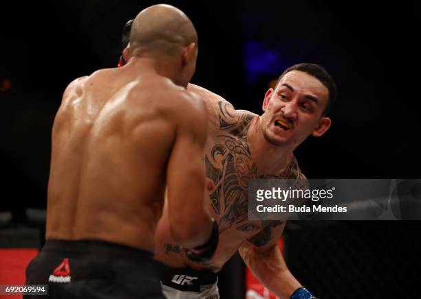 Max Holloway punches Jose Aldo of Brazil in their UFC featherweight championship bout during the UFC 212 event at Jeunesse Arena on June 3, 2017 in...