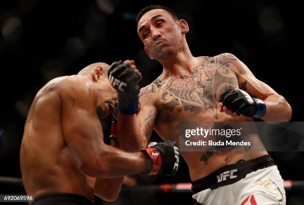 Max Holloway punches Jose Aldo of Brazil in their UFC featherweight championship bout during the UFC 212 event at Jeunesse Arena on June 3, 2017 in...