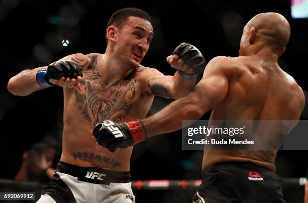 Max Holloway punches Jose Aldo of Brazil in their UFC featherweight championship bout during the UFC 212 event at Jeunesse Arena on June 3, 2017 in...