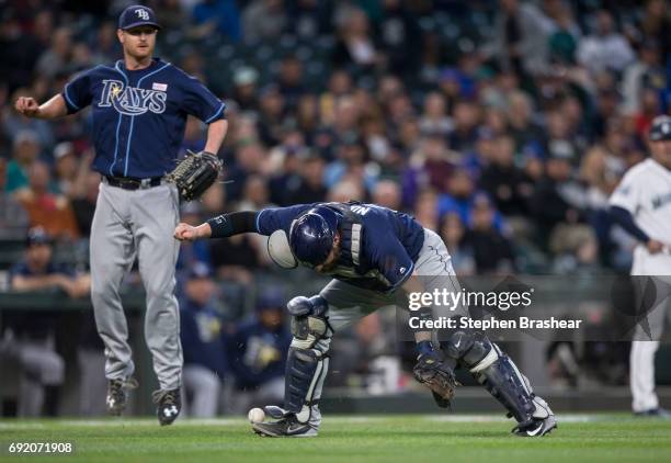 Catcher Derek Norris of the Tampa Bay Rays cannot handle a bunt by Jarrod Dyson of the Seattle Mariners during the fifth inning of a game at Safeco...