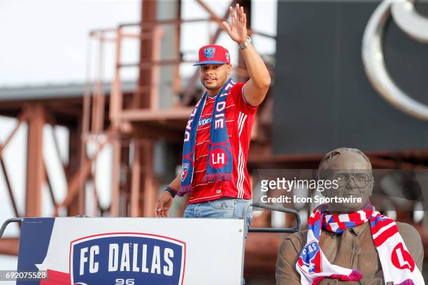 Dallas Cowboys QB Dak Prescott places the scarf on the Lamar Hunt statue prior to the MLS match between Real Salt Lake and FC Dallas on June 3, 2017...