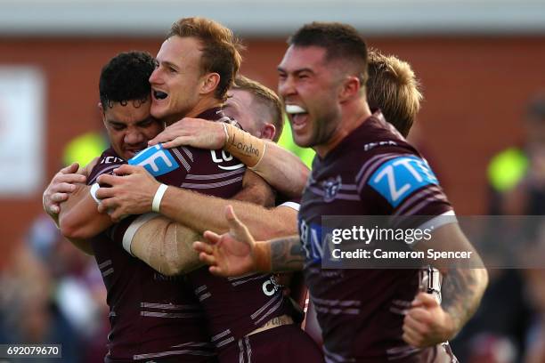 Daly Cherry-Evans of the Sea Eagles celebrates with team mates after kicking the winning field goal in extra-time during the round 13 NRL match...