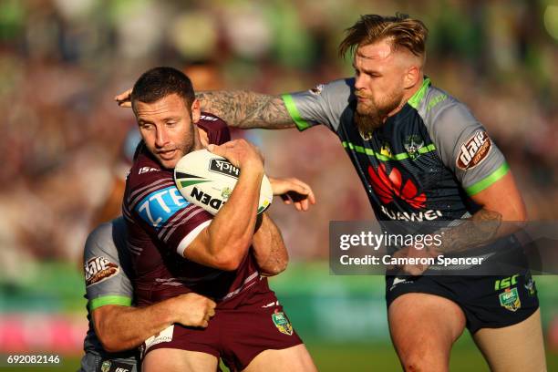 Blake Green of the Sea Eagles is tackled during the round 13 NRL match between the Manly Sea Eagles and the Canberra Raiders at Lottoland on June 4,...