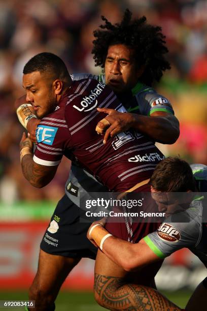 Addin Fonua-Blake of the Sea Eagles is tackled during the round 13 NRL match between the Manly Sea Eagles and the Canberra Raiders at Lottoland on...