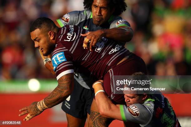 Addin Fonua-Blake of the Sea Eagles is tackled during the round 13 NRL match between the Manly Sea Eagles and the Canberra Raiders at Lottoland on...