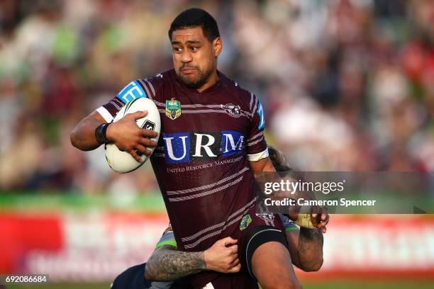 Matthew Wright of the Sea Eagles is tackled during the round 13 NRL match between the Manly Sea Eagles and the Canberra Raiders at Lottoland on June...