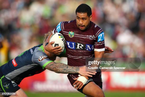 Matthew Wright of the Sea Eagles is tackled during the round 13 NRL match between the Manly Sea Eagles and the Canberra Raiders at Lottoland on June...