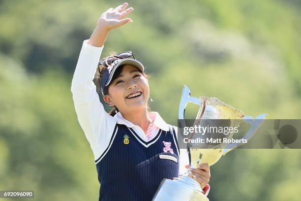 Serena Aoki of Japan acknowledges the crowd as she holds the winners trophy during the final round of the Yonex Ladies Golf Tournament 2016 at the...