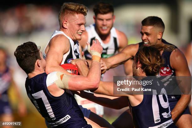 Adam Treloar of the Magpies gets tackled by Lachie Neale of the Dockers during the round 11 AFL match between the Fremantle Dockers and the...