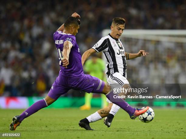 Paulo Dybala of Juventus is tackled by Casemiro of Real Madrid during the UEFA Champions League Final match between Juventus and Real Madrid at...