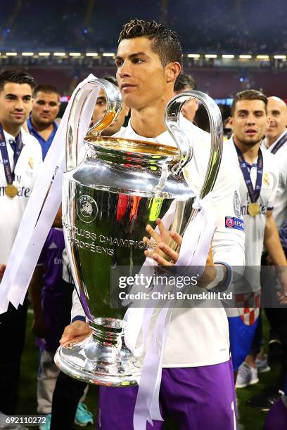 Cristiano Ronaldo of Real Madrid holds the trophy following the UEFA Champions League Final match between Juventus and Real Madrid at the National...