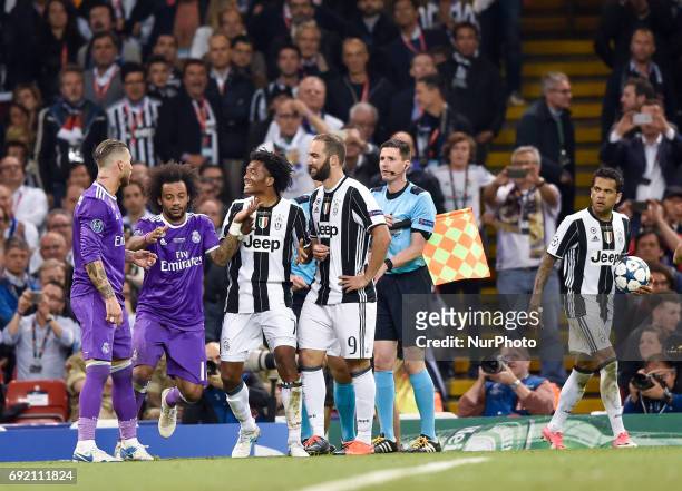 Juan Cuadrado of Juventus gets a red card during the UEFA Champions League Final match between Real Madrid and Juventus at the National Stadium of...