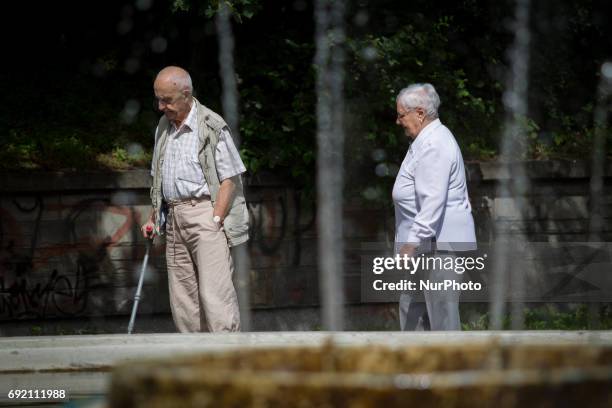An elderly couple is seen in a park in the center of Bydgoszcz, Poland on 3 June, 2017.