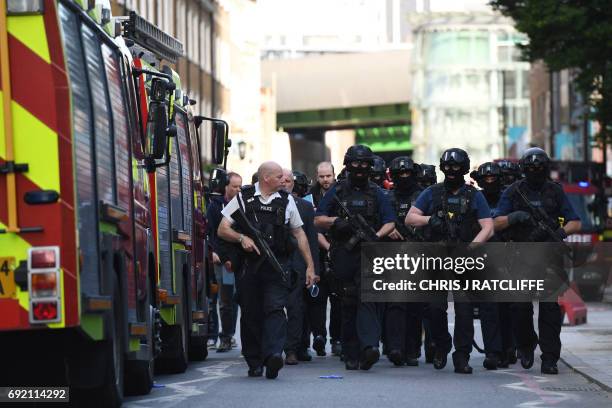 Armed police officers arrive at The Shard in the London Bridge quarter in London on June 4 following a terror attack. Forty-eight people have been...