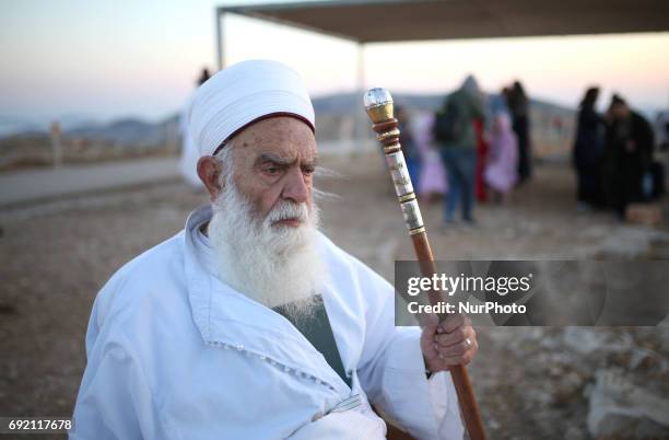 Member of the ancient Samaritan community prays as he prepares to take part in the traditional pilgrimage marking the holiday of Shavuot, atop Mount...