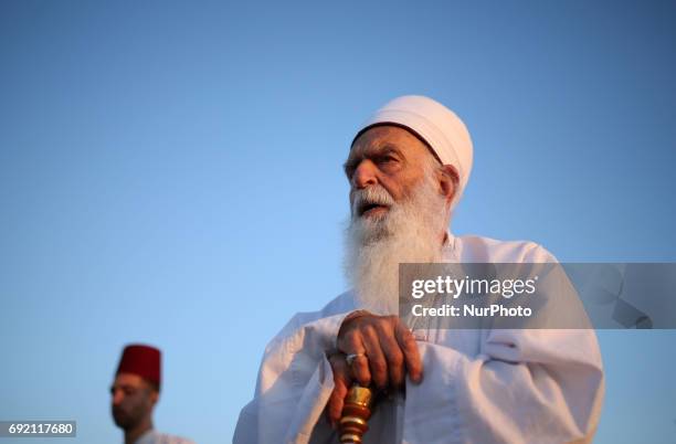 Member of the ancient Samaritan community prays as he prepares to take part in the traditional pilgrimage marking the holiday of Shavuot, atop Mount...