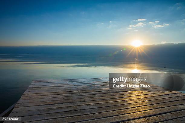 lake at sunset - linghe zhao stock pictures, royalty-free photos & images