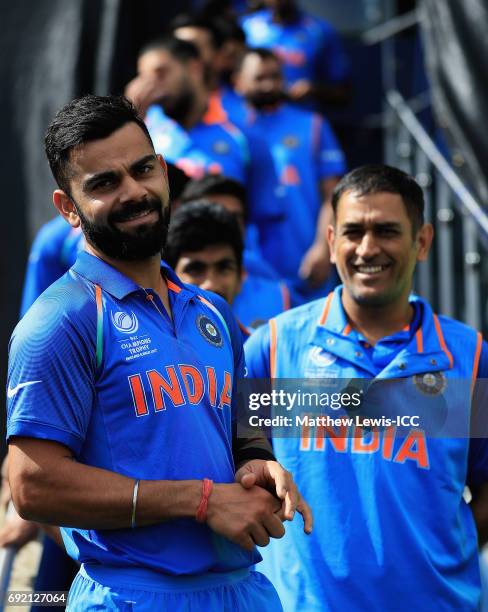 Virat Kohli of India looks on with MS Dhoni, ahead of the ICC CHampions Trophy match between India and Pakistan at Edgbaston on June 4, 2017 in...