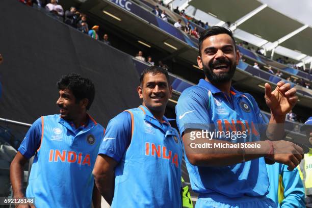 India captain Virat Kohli alongside MS Dhoni and Jasprit Bumrah as the teams wait for the national anthems during the ICC Champions Trophy match...