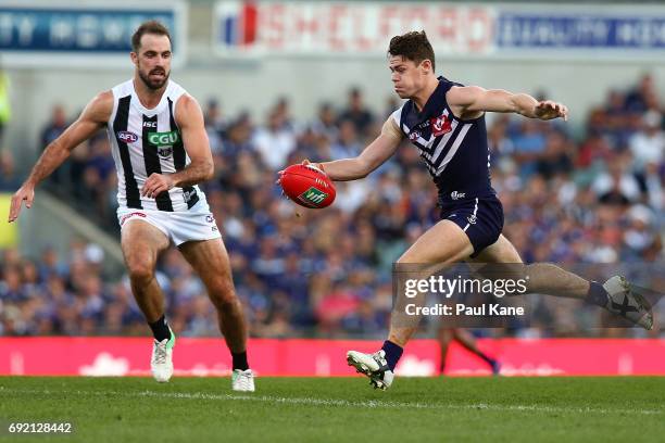 Lachie Neale of the Dockers kicks the ball into the forward line during the round 11 AFL match between the Fremantle Dockers and the Collingwood...
