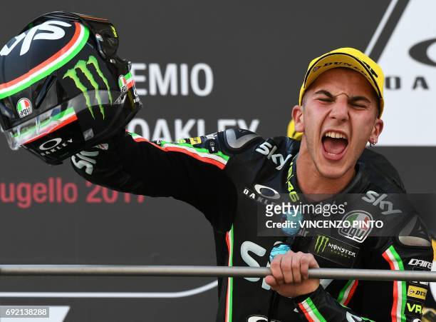 Sky Racing Team VR46 rider Italian Andrea Migno celebrates on the podium after winning the Moto 3 Grand Prix at the Mugello race track on June 4,...
