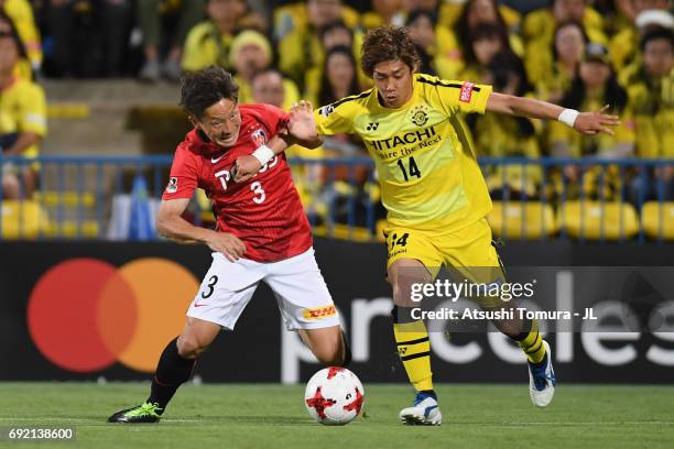 Junya Ito of Kashiwa Reysol and Tomoya Ugajin of Urawa Red Diamonds compete for the ball during the J.League J1 match between Kashiwa Reysol and...